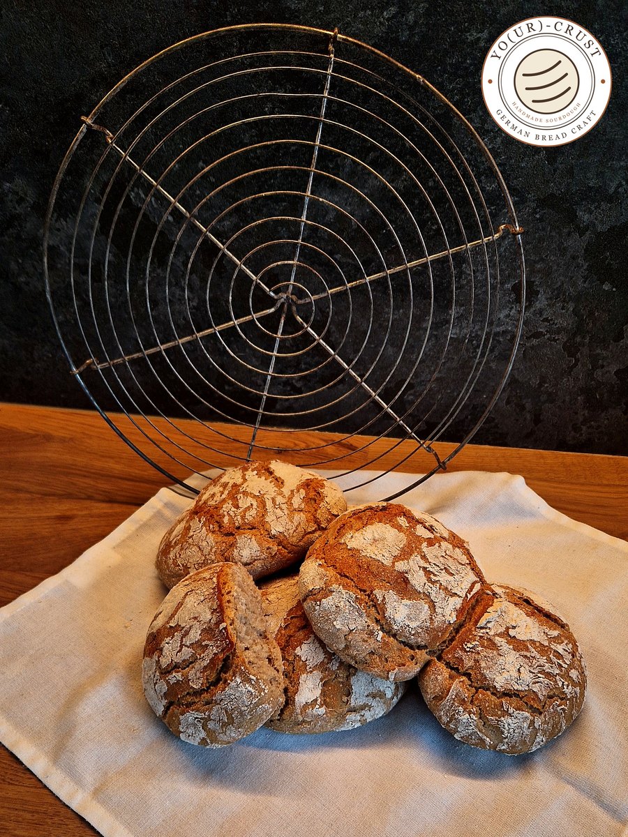 Vinschgauer — spiced South Tyrolean rye rolls cooling on a wire rack